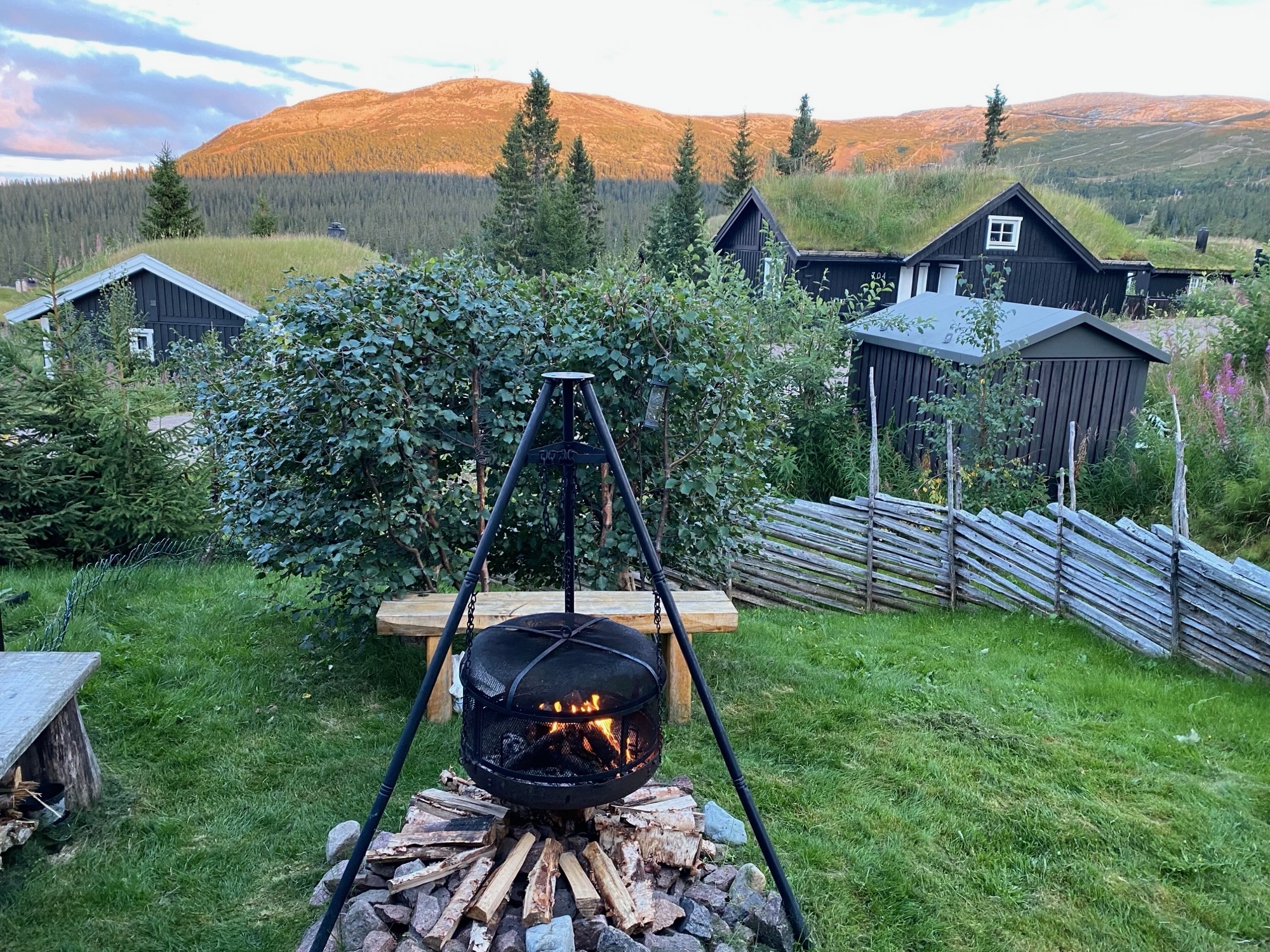 Outdoor fire pit with grill in the garden and mountain views.